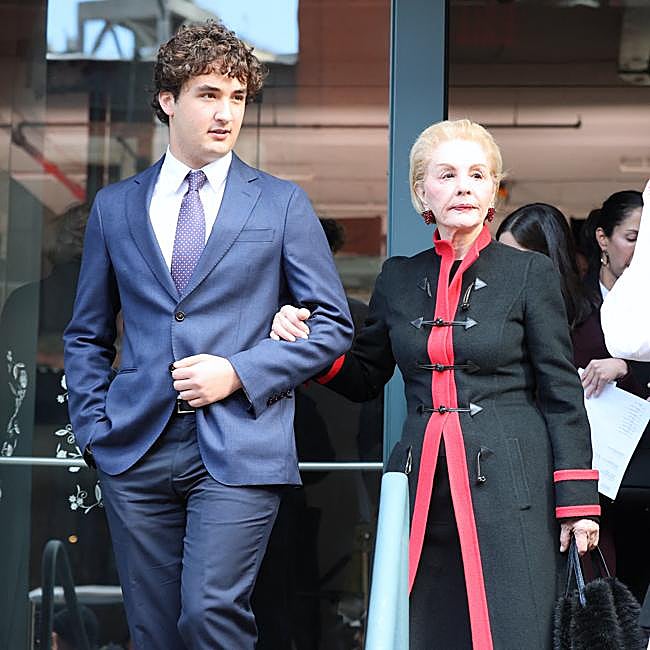 Carolina Herrera, exiting the show, on the arm of one of her grandchildren.