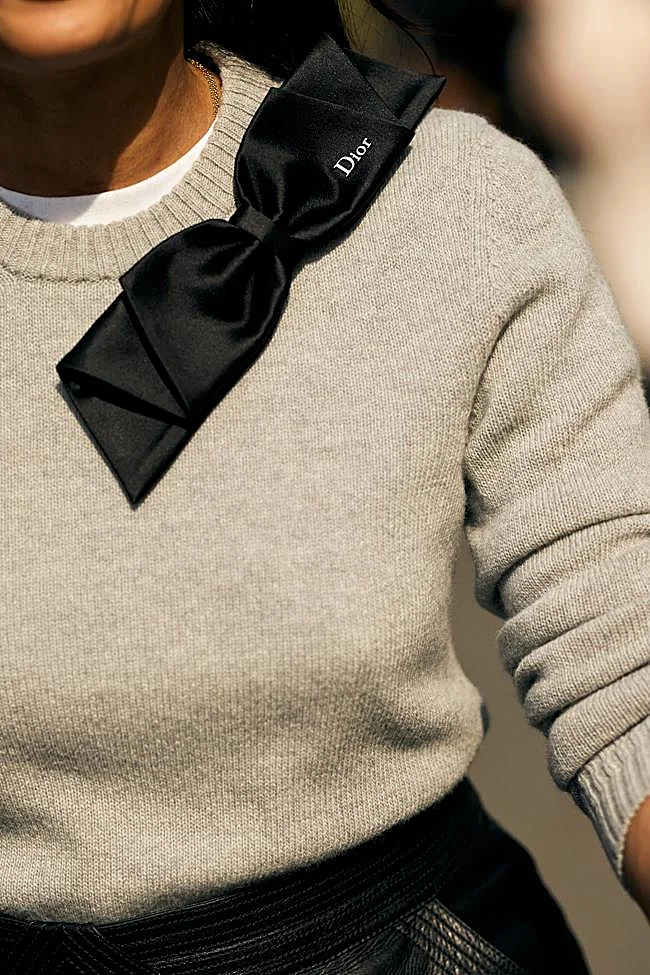 Un look con jersey y detalle de accesorio con lazo.